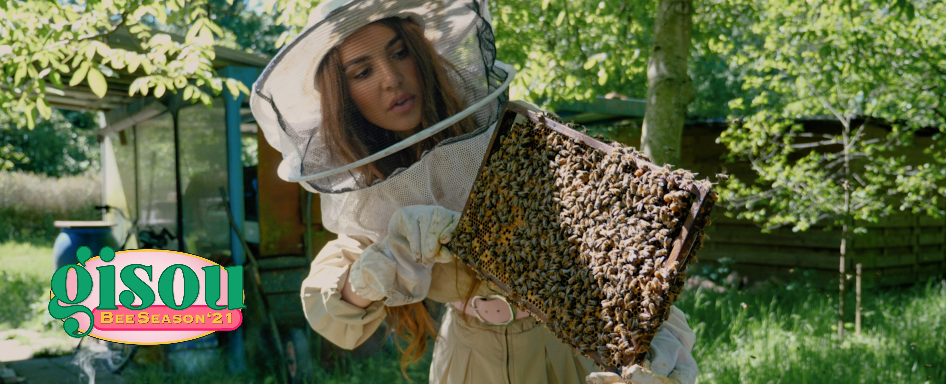Negin holding a tray of bees in the Mirsalehi bee garden