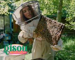 Negin holding a tray of bees in the Mirsalehi bee garden