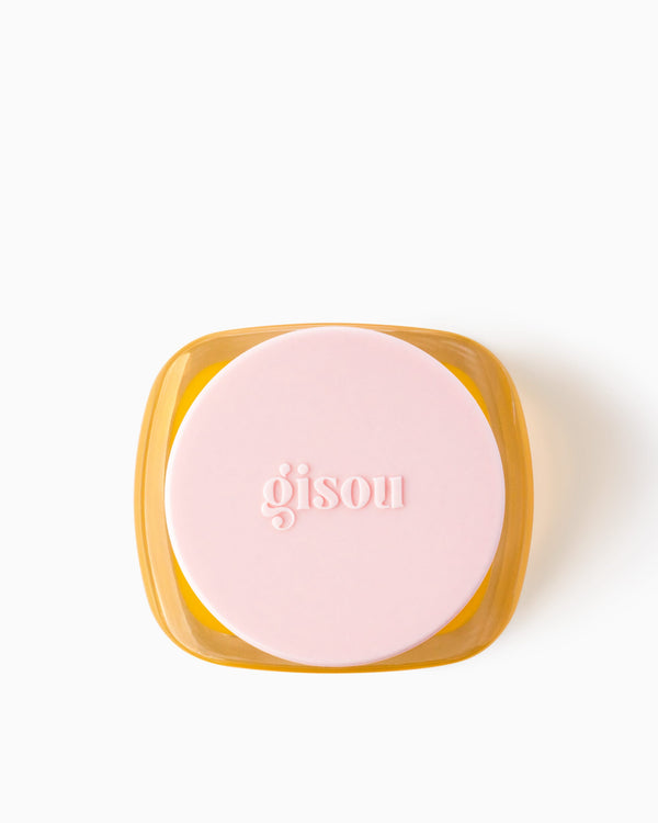 A jar of Honey Infused Beauty Balm from the top perspective